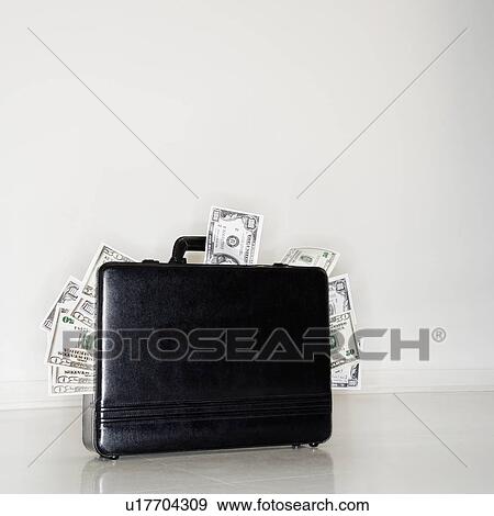 Briefcase overflowing with money View Large Photo Image Stock Photo - Briefcase overflowing with money. Fotosearch