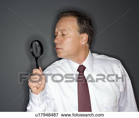Stock Photo - Businessman analyzing. Fotosearch