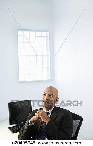Stock Photo - Businessman at office desk.. Fotosearch