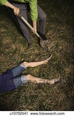 dead body businessman burying fotosearch