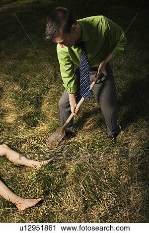 dead businessman burying body fotosearch