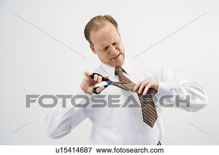 Businessman cutting necktie View Large Photo Image Stock Photo - Businessman cutting necktie. Fotosearch
