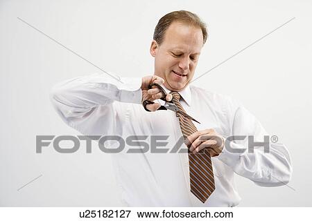 Businessman cutting necktie View Large Photo Image Stock Photo - Businessman cutting necktie. Fotosearch