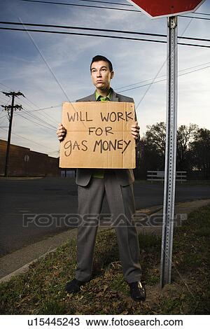 Businessman Holding Gas Money Sign View Large Photo Image Stock Image - Businessman Holding Gas Money Sign. Fotosearch