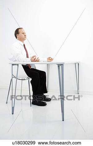 Stock Photo - Businessman meditating. Fotosearch