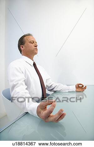 Businessman meditating View Large Photo Image Stock Photo - Businessman meditating. Fotosearch