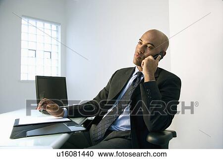 Stock Image - Businessman on cellphone.. Fotosearch