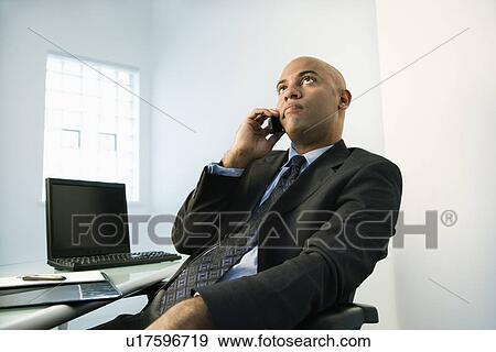 Stock Photo - Businessman on cellphone. Fotosearch