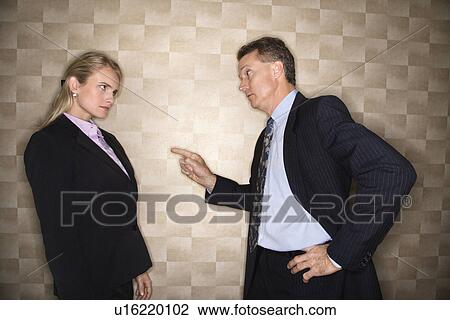 Stock Image - Businessman Reprimanding Businesswoman. Fotosearch