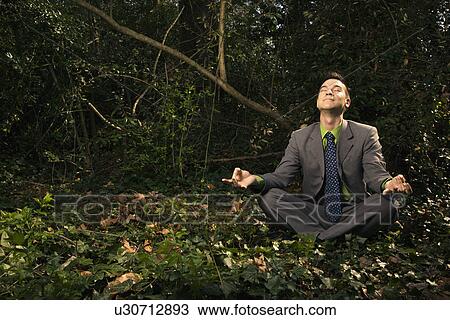 Stock Image - Businessman Sitting in Meditation Outside. Fotosearch