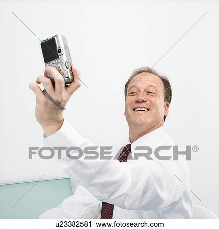 Businessman taking photo of self View Large Photo Image Stock Image - Businessman taking photo of self. Fotosearch