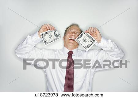 Businessman wasting money View Large Photo Image Stock Photo - Businessman wasting money. Fotosearch