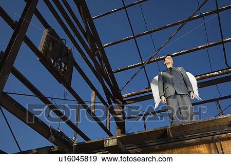 Stock Photo - Businessman Wearing Angel Wings. Fotosearch