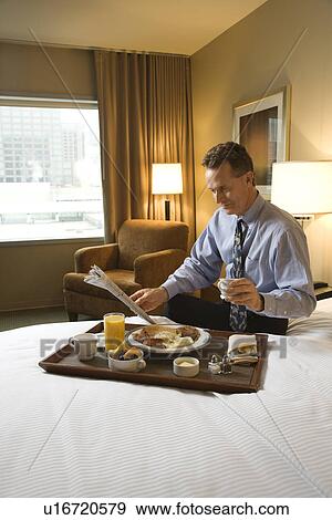Stock Photo - Businessman with Hotel Room Service. Fotosearch
