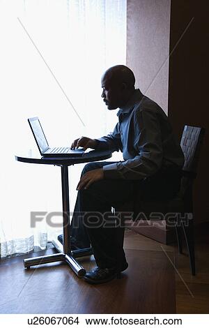 Picture - Businessman with Laptop at Cafe Table. Fotosearch