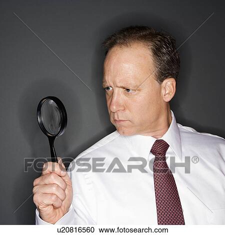 Businessman with magnifying glass View Large Photo Image Stock Image - Businessman with magnifying glass. Fotosearch