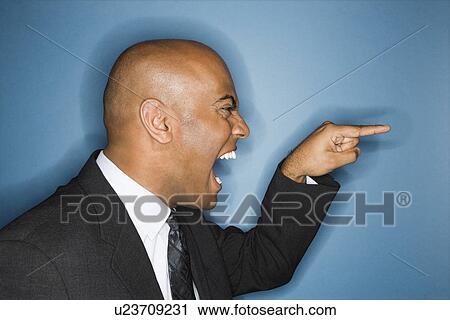 Businessman yelling and pointing View Large Photo Image Stock Image - Businessman yelling and pointing. Fotosearch