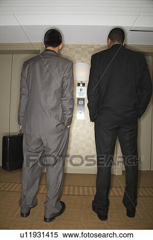Stock Photography - Businessmen Waiting for Elevator. Fotosearch