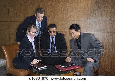 Businesspeople Gathered Around a Laptop View Large Photo Image Stock Image - Businesspeople Gathered Around a Laptop. Fotosearch