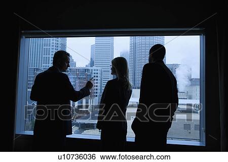 Stock Photograph - Businesspeople Looking Out the Window. Fotosearch