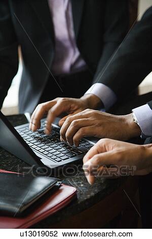 Stock Image - Businesspeople With Laptop. Fotosearch