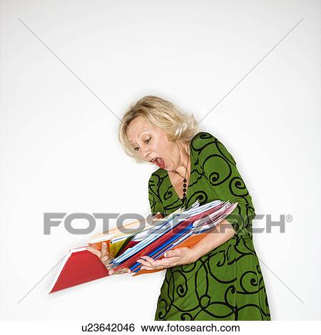 Stock Photograph - Businesswoman dropping folders. Fotosearch
