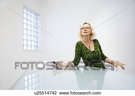 Stock Image - Businesswoman holding cellphone. Fotosearch