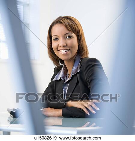 Stock Photo - Businesswoman in office. Fotosearch