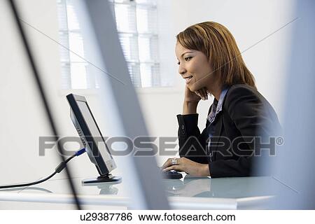 Stock Photograph - Businesswoman on computer. Fotosearch