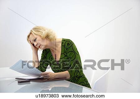 Businesswoman reading document View Large Photo Image Stock Image - Businesswoman reading document. Fotosearch