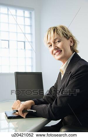 Stock Image - Businesswoman smiling. Fotosearch