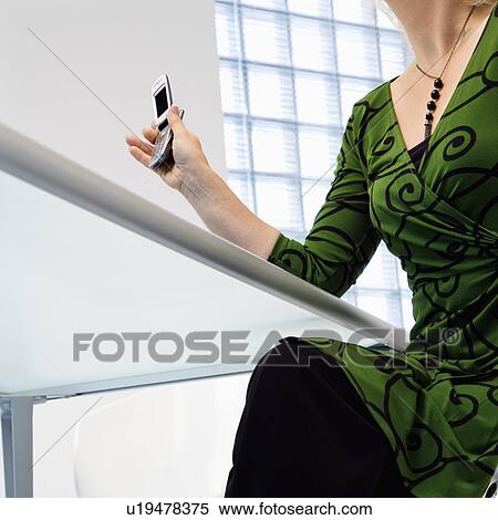 Stock Photography - Businesswoman with cellphone. Fotosearch