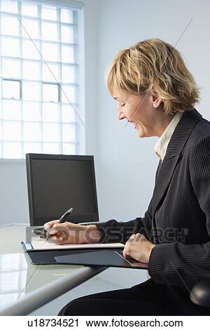 Stock Image - Businesswoman working. Fotosearch