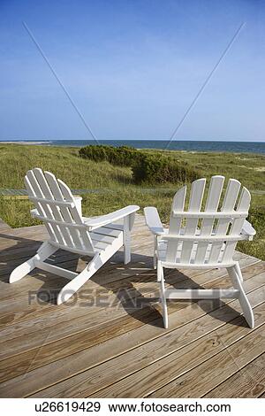 Stock Photo - Chairs on Deck Facing Ocean. Fotosearch