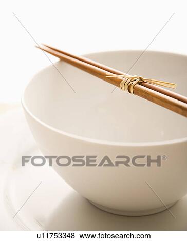Chopsticks on an Empty Bowl. Isolated View Large Photo Image Stock Photo - Chopsticks on an Empty Bowl. Isolated. Fotosearch