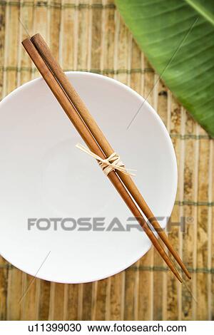 Stock Image - Chopsticks on an Empty Bowl. Fotosearch