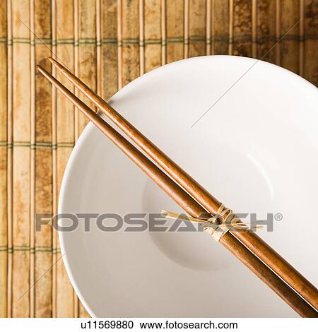 Stock Image - Chopsticks on an Empty Bowl. Fotosearch