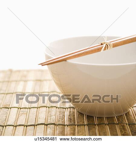 Stock Image - Chopsticks on an Empty Bowl. Fotosearch