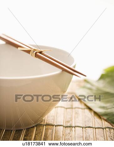 Stock Image - Chopsticks on an Empty Bowl. Fotosearch