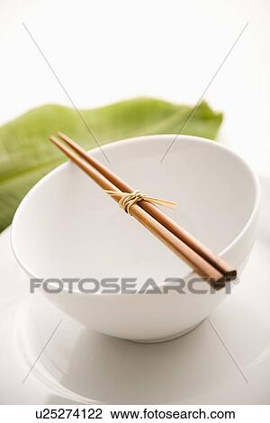 Stock Image - Chopsticks on an Empty Bowl. Fotosearch