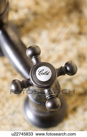 Stock Image - Close-Up of Cold Water Faucet Handle. Fotosearch