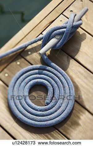 Stock Image - Coiled Rope on Dock. Fotosearch