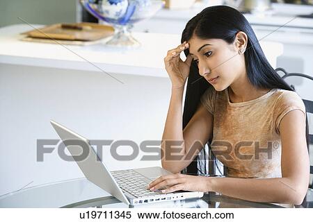 Concerned Young Woman Using Laptop View Large Photo Image Stock Photography - Concerned Young Woman Using Laptop. Fotosearch