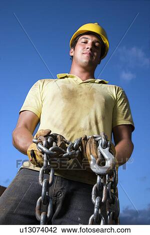 Stock Image - Construction Worker Holding Chain. Fotosearch