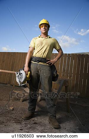 Construction Worker Standing with Saw View Large Photo Image Stock Image - Construction Worker Standing with Saw. Fotosearch