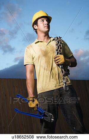 Construction Worker with Bolt Cutters and Chain View Large Photo Image Stock Photo - Construction Worker with Bolt Cutters and Chain. Fotosearch