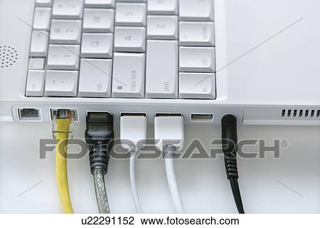 Stock Image - Cords Plugged Into Laptop Computer. Fotosearch