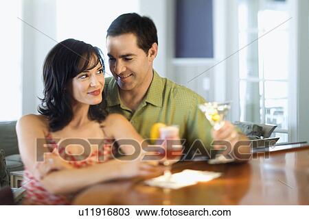 Stock Image - Couple at Bar Smiling and Drinking. Fotosearch