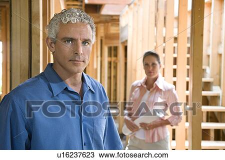 Stock Image - Couple Building Home. Fotosearch