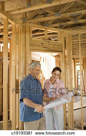 Stock Image - Couple Building Home. Fotosearch
